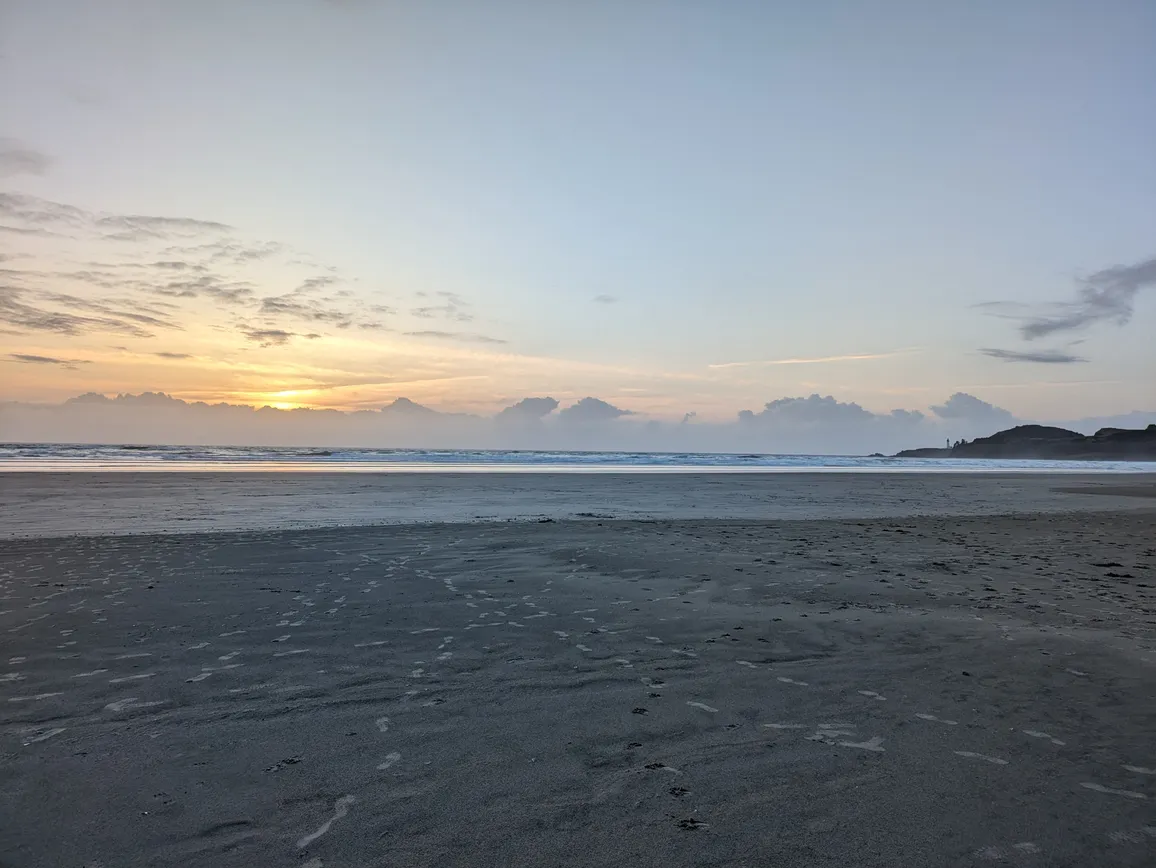 Sunset with footprints on Agate Beach, Newport, Oregon.